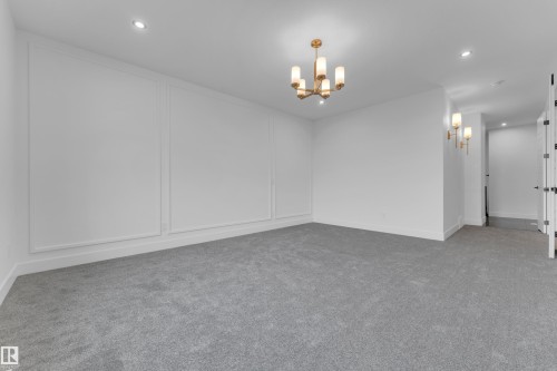 Spacious room featuring light gray carpeting and white walls - 7677 Kimiwan Crescent, Edmonton, AB 
