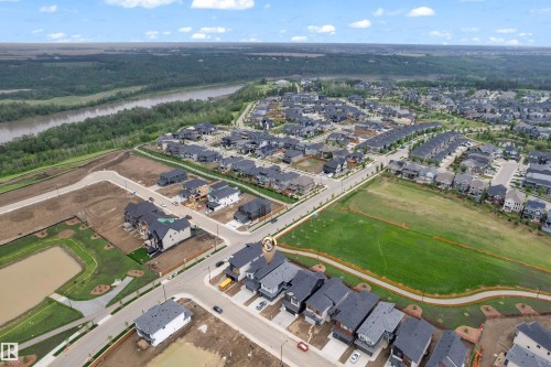 Aerial perspective of a developed residential area featuring various housing styles and dark-pitched roofs - 7677 Kimiwan Crescent, Edmonton, AB 