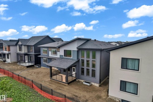 Contemporary architecture featuring multi-pane window elements and varied exterior finishes - 7677 Kimiwan Crescent, Edmonton, AB 