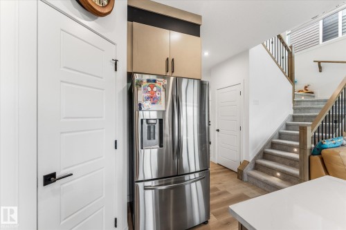 Stainless steel refrigerator with a water and ice dispenser, integrated into cabinetry - 94 Elm Street, Fort Saskatchewan, AB 