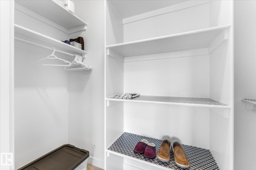Built-in shelving system featuring multiple storage levels and hanging rods - 94 Elm Street, Fort Saskatchewan, AB 