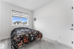 Interior room featuring light gray carpeting, white baseboards, and a white window frame - 