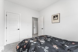 Light gray carpeted flooring paired with white walls, contemporary white paneled doors, and matte black hardware - 