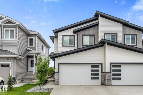 Modern facade with horizontal siding, dark trim accents, and stone detailing - 94 Elm Street, Fort Saskatchewan, AB 