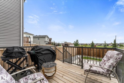 Elevated wood deck with dark metal railings and exterior siding - 94 Elm Street, Fort Saskatchewan, AB 