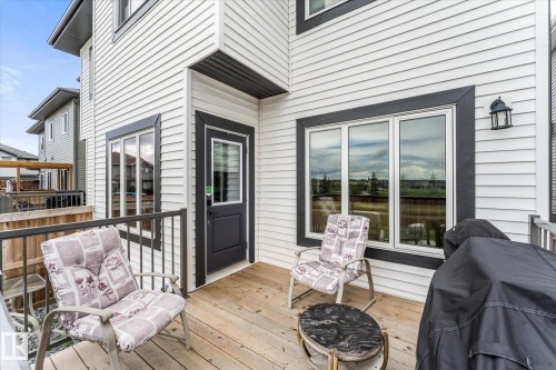 Spacious wood-finish deck with black metal railings - 94 Elm Street, Fort Saskatchewan, AB 