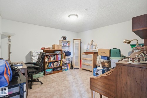 Neutral wall tones with textured ceiling and central flush-mount lighting - 1223 9363 Simpson Dr, Edmonton, AB 