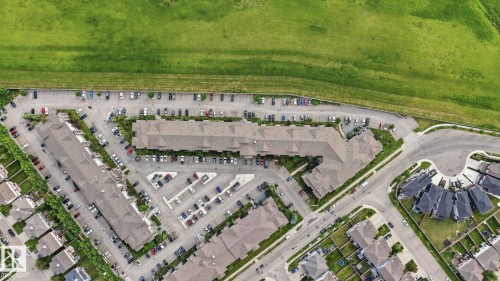 Aerial perspective of a multi-unit residential complex featuring extensive surface parking - 1223 9363 Simpson Dr, Edmonton, AB 