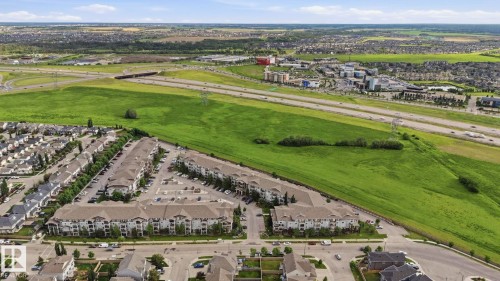 Expansive aerial perspective showcasing a residential community with multiple multi-story buildings and single-family homes - 1223 9363 Simpson Dr, Edmonton, AB 