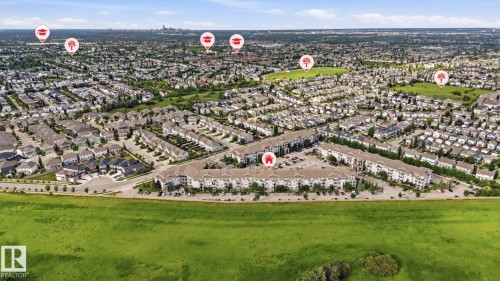 Expansive aerial perspective showcasing a residential community with a mix of detached homes and multi-unit buildings - 1223 9363 Simpson Dr, Edmonton, AB 