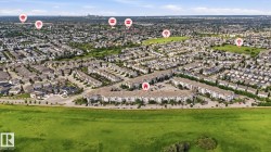 Expansive aerial perspective showcasing a residential community with a mix of detached homes and multi-unit buildings - 