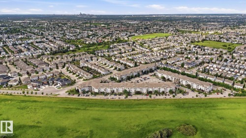 Expansive suburban landscape featuring a mix of single-family homes and multi-unit residential buildings - 1223 9363 Simpson Dr, Edmonton, AB 