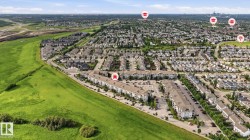 Expansive aerial perspective showcasing a residential development with an abundance of detached homes and multi-family buildings - 