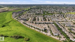 Expansive suburban development featuring a mix of single-family residences and multi-story apartment buildings - 