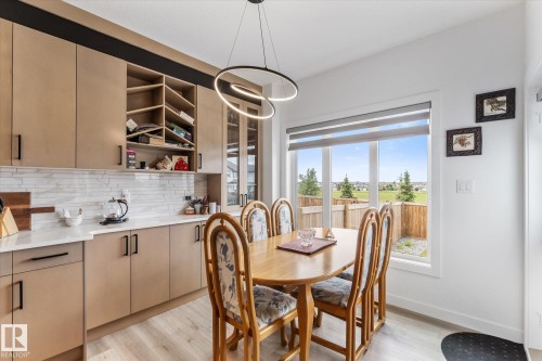 Kitchen featuring light wood-finish cabinetry, white countertop, and white subway tile backsplash - 92 Elm Street, Fort Saskatchewan, AB 