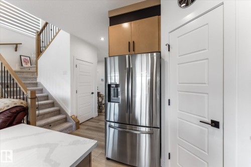 Stainless steel French door refrigerator with water dispenser, integrated into cabinetry - 92 Elm Street, Fort Saskatchewan, AB 