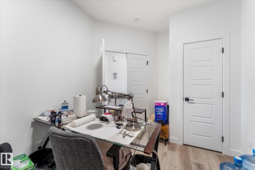 Light wood-finish flooring complements the crisp white walls - 92 Elm Street, Fort Saskatchewan, AB 