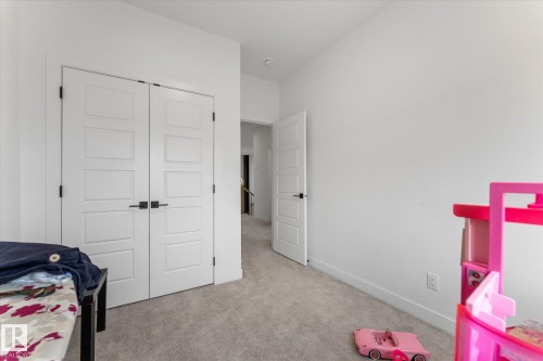 Neutral wall finishes, recessed lighting, and soft carpeting provide a versatile interior - 92 Elm Street, Fort Saskatchewan, AB 