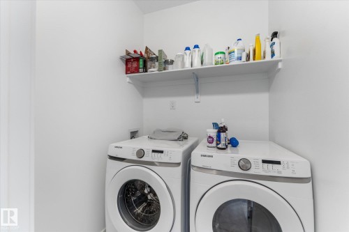 Dedicated laundry space featuring white walls and an integrated storage shelf - 92 Elm Street, Fort Saskatchewan, AB 