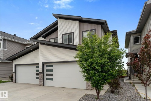 Contemporary exterior featuring light-colored siding and dark trim accents - 92 Elm Street, Fort Saskatchewan, AB 