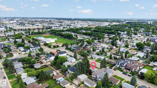 Residential neighborhood featuring a mix of housing styles, mature trees, and paved streets - 10924 154 Street, Edmonton, AB 