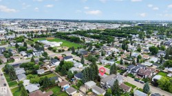 Residential neighborhood featuring a mix of housing styles, mature trees, and paved streets - 