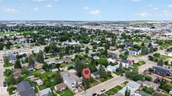 Residential neighborhood with mature trees and a mix of single-family homes and multi-unit properties - 