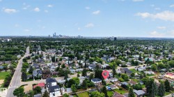 Aerial perspective showcasing a residential neighborhood with a distant urban skyline - 