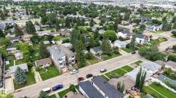 Aerial perspective showcasing a residential area with mature trees and established properties - 