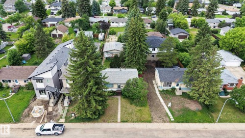 Aerial perspective showcasing multiple residential properties surrounded by mature trees - 10924 154 Street, Edmonton, AB 