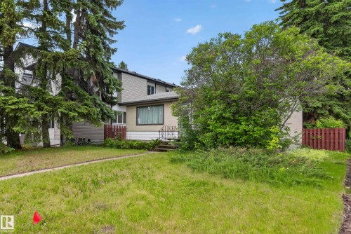 Split-level residence featuring a muted beige facade and large front window - 10924 154 Street, Edmonton, AB 