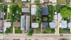 Aerial perspective showcasing a residential street with multiple properties - 