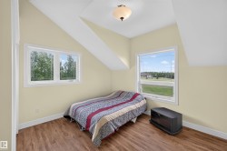 Room featuring wood-finish flooring and sloped ceilings - 