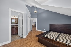 Vaulted ceilings and wood-finish flooring characterize this interior space - 