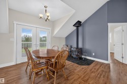 Hardwood-finish flooring throughout, featuring a wood-burning stove with a tile hearth - 