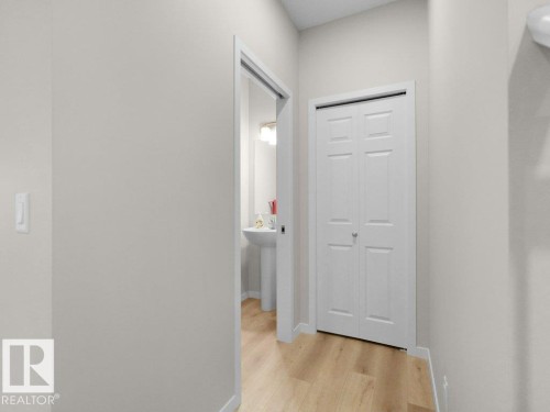 Recessed lighting illuminates the hall with wood-finish flooring - 2039 13 Avenue, Edmonton, AB 