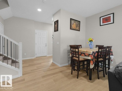 Light wood-finish flooring extends throughout the main level - 2039 13 Avenue, Edmonton, AB 