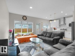 Open-concept living area with a contemporary kitchen - 