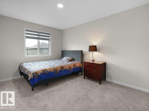 Bedroom featuring neutral-toned walls, gray carpet, a single window with blinds, and a recessed ceiling light - 2039 13 Avenue, Edmonton, AB 
