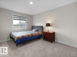 Bedroom featuring neutral-toned walls, gray carpet, a single window with blinds, and a recessed ceiling light - 
