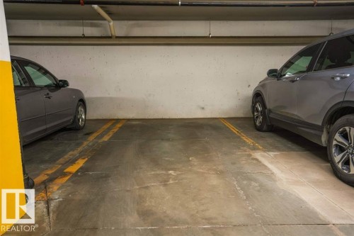 Dedicated parking space within a subterranean garage - #117 226 Macewan Sw, Edmonton, AB - Indoor Photo Showing Garage