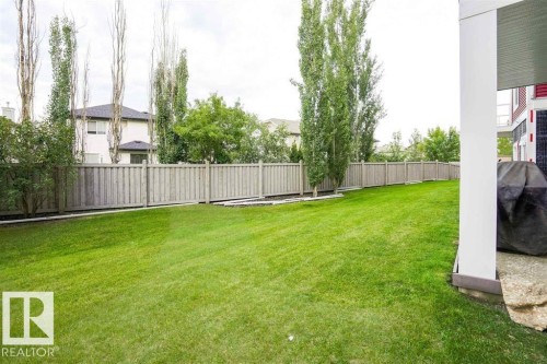 Expansive green lawn providing ample outdoor space - #117 226 Macewan Sw, Edmonton, AB - Outdoor