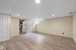 Finished lower level featuring wood-finish flooring, recessed lighting, and neutral wall tones - 
