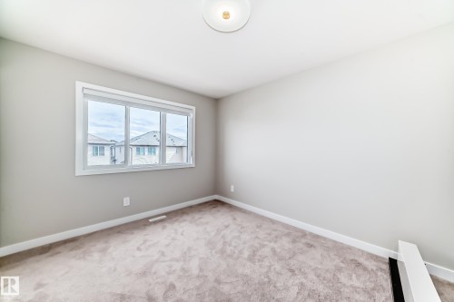 Bedroom featuring gray carpeting, light gray wall paint, and white trim - 4231 206 Street, Edmonton, AB 