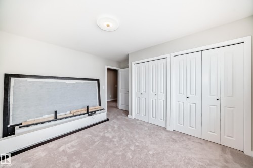 Plush carpeted flooring complementing light-toned walls - 4231 206 Street, Edmonton, AB 