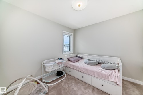 Bright room with a neutral color palette, featuring a single window, overhead lighting, and carpeted flooring - 4231 206 Street, Edmonton, AB 
