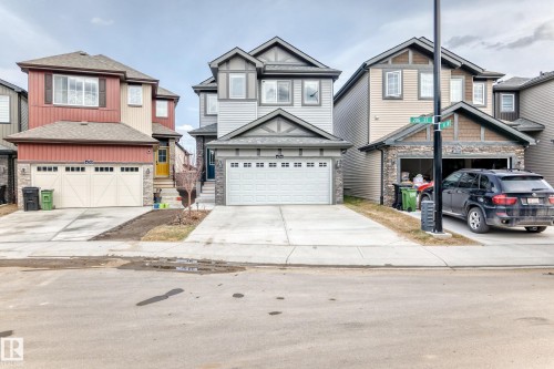 Modern two-story home featuring a grey siding exterior with dark grey trim accents - 4231 206 Street, Edmonton, AB 