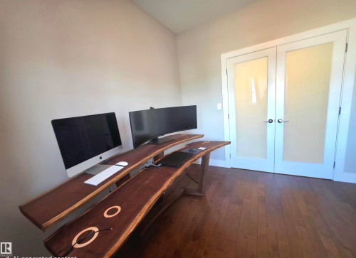 Room featuring hardwood flooring and light gray painted walls - 1 Hemlock Close, Fort Saskatchewan, AB 