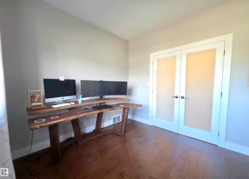 Hardwood flooring throughout featuring a neutral wall palette and white trim - 1 Hemlock Close, Fort Saskatchewan, AB 