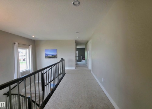 Upper-level hallway with neutral wall tones and recessed lighting - 1 Hemlock Close, Fort Saskatchewan, AB 